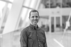 Portrait of Itan Barmes, Co-founder & CSO at Qiz Security, delivering a keynote at Dutch Blockchain Week 2026 in Amsterdam.