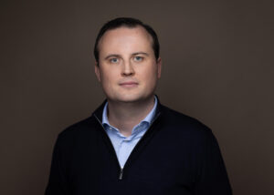 Portrait of Brian Gahan, General Manager Europe at Kraken, delivering a keynote at Dutch Blockchain Week 2026 in Amsterdam.