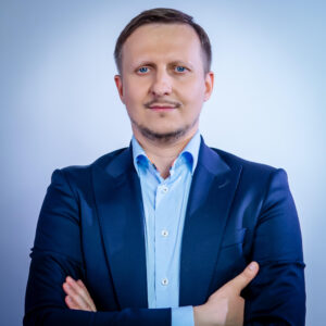 Portrait of Paweł Łaskarzewski, CEO at Nomad Fulcrum, delivering a keynote at Dutch Blockchain Week 2026 in Amsterdam.